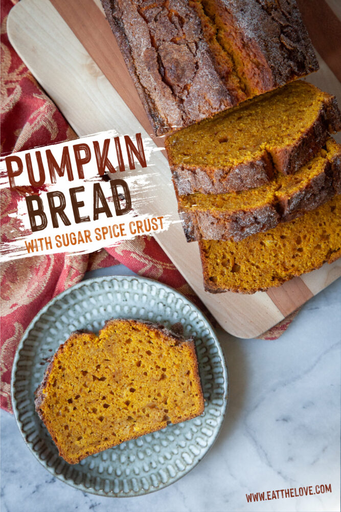 A slice of pumpkin bread on a plate, with the remaining pumpkin bread next to it on a cutting board.