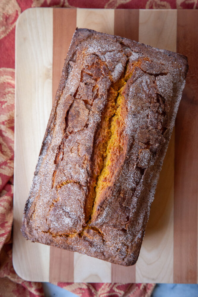 A pumpkin bread on a cutting board,