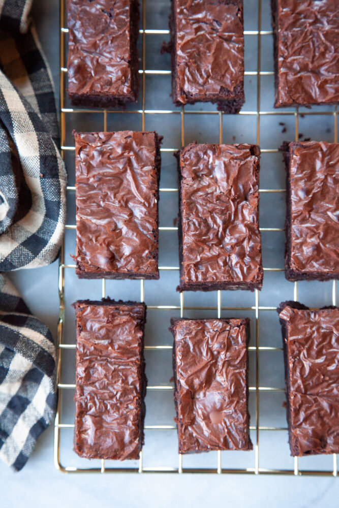 Fudge brownies on a wire cooling rack.