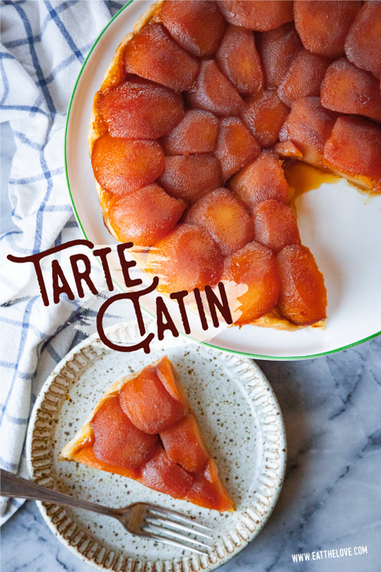 Tarte Tatin on a serving platter, with a slice of tarte tatin on a small plate next to it.