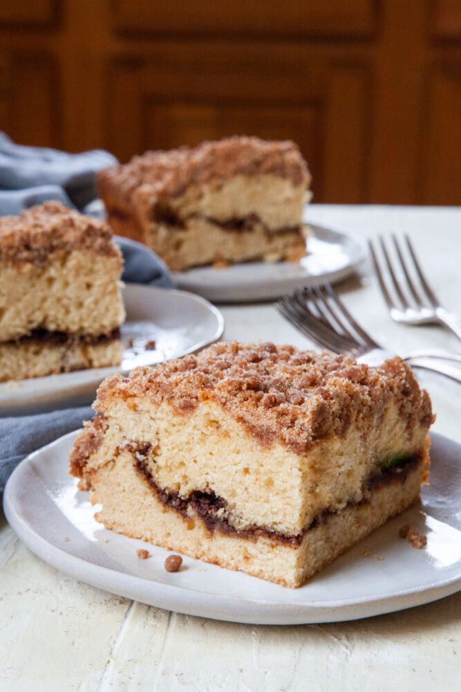 Pieces of cinnamon streusel coffee cake on a plates. 