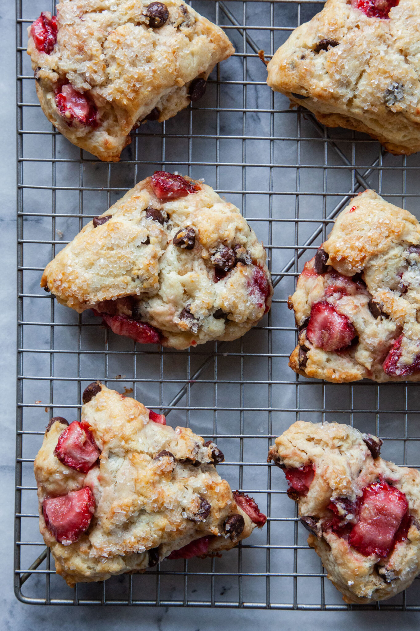 Chocolate and strawberry scones on a wire cooling rack.