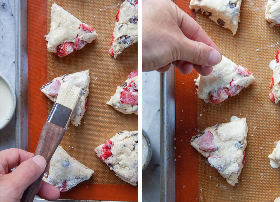 Left image is a hand brushing heavy cream on top of the scones. Right image is a hand sprinkling coarse sugar on top of the scones.