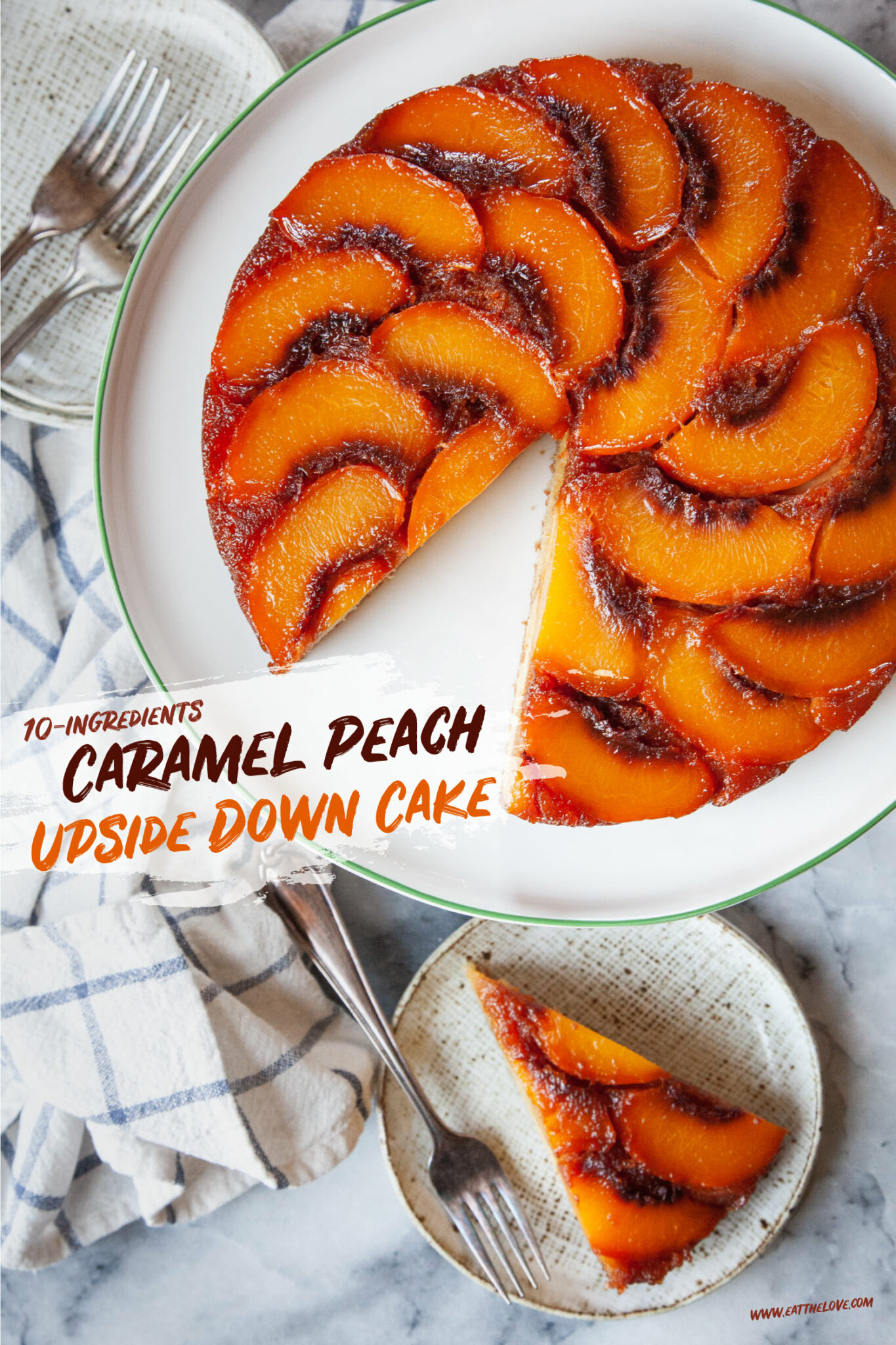 A caramel peach upside down cake on a cake platter, with a slice of the cake cut out and sitting on a small cake plate next to it. There is a cloth napkin next to the plate.