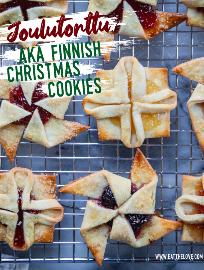 Joulutorttu, AKA Finnish Christmas Cookies, jam filled cookies in the shape of pinwheels and square flowers, sitting on a wire cooling rack. The text on the image says Joulutorttu AKA Finnish Christmas Cookies.