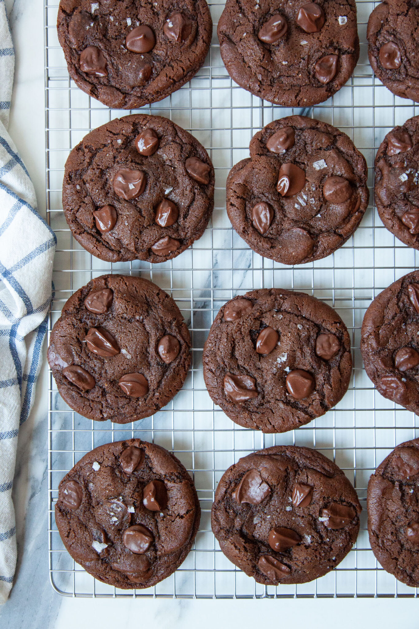 Mocha chocolate chip cookies sitting on a wire cooling rack.