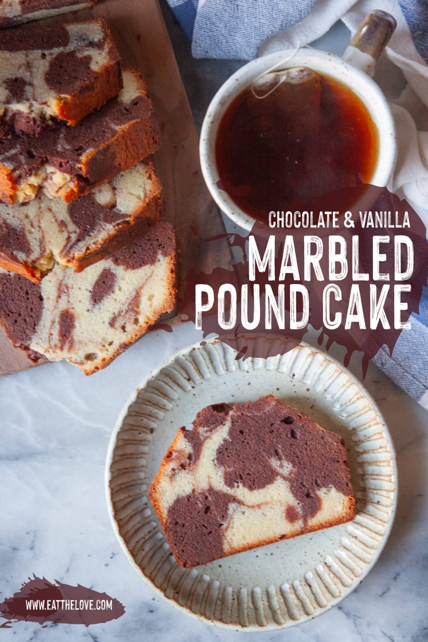 A slice of marbled pound cake on a plate, with the rest of the cake on a cutting board next to it along with a mug of tea.