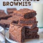 A stack of Kahlua espresso brownies on a plate, with more brownies behind it. The words on the image say "Kahlua Espresso Brownies".