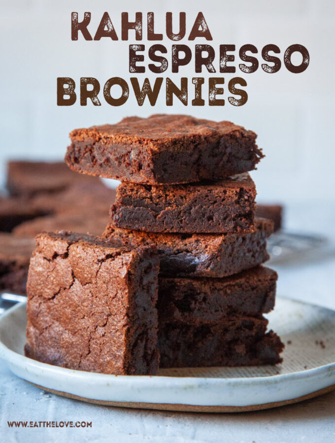 A stack of Kahlua espresso brownies on a plate, with more brownies behind it. The words on the image say "Kahlua Espresso Brownies".