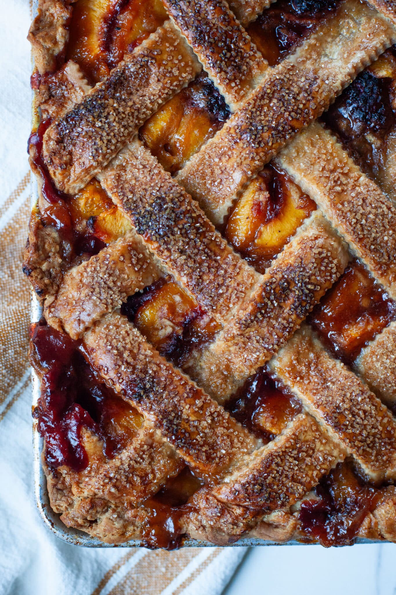 A peach and blackberry slab pie with a woven top crust.