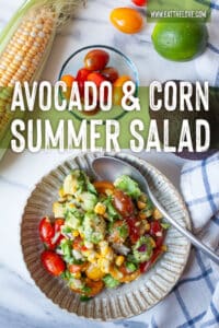 A bowl of avocado and corn salad, with an ear of corn, grape tomatoes, and a lime next to the bowl. The type on the image says Avocado and Corn Summer Salad.