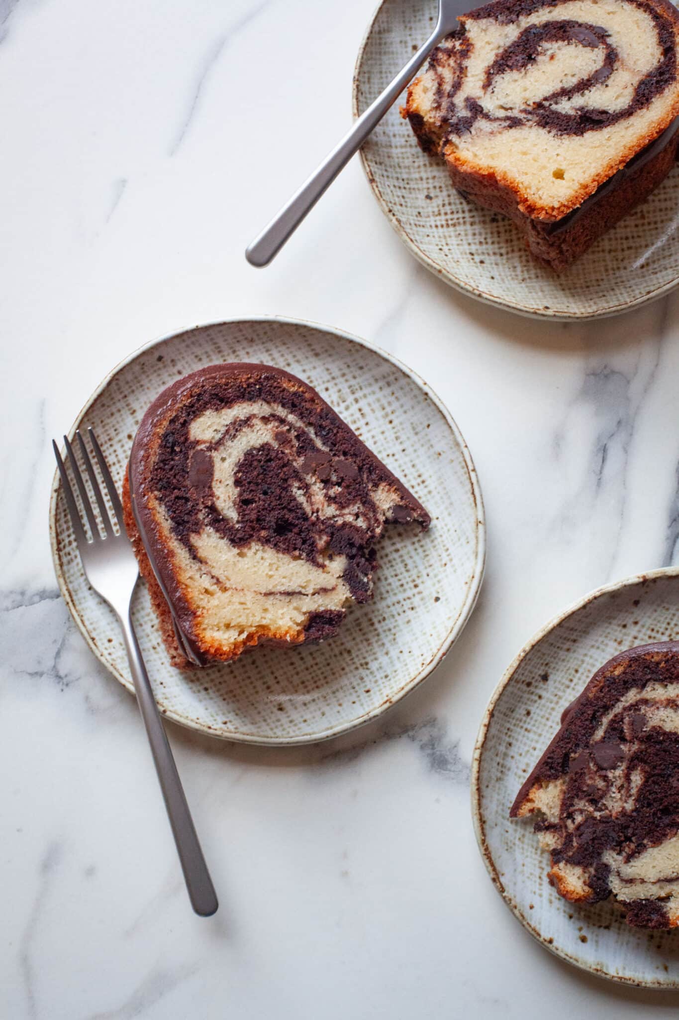 Slices of marble bundt cake on plates.